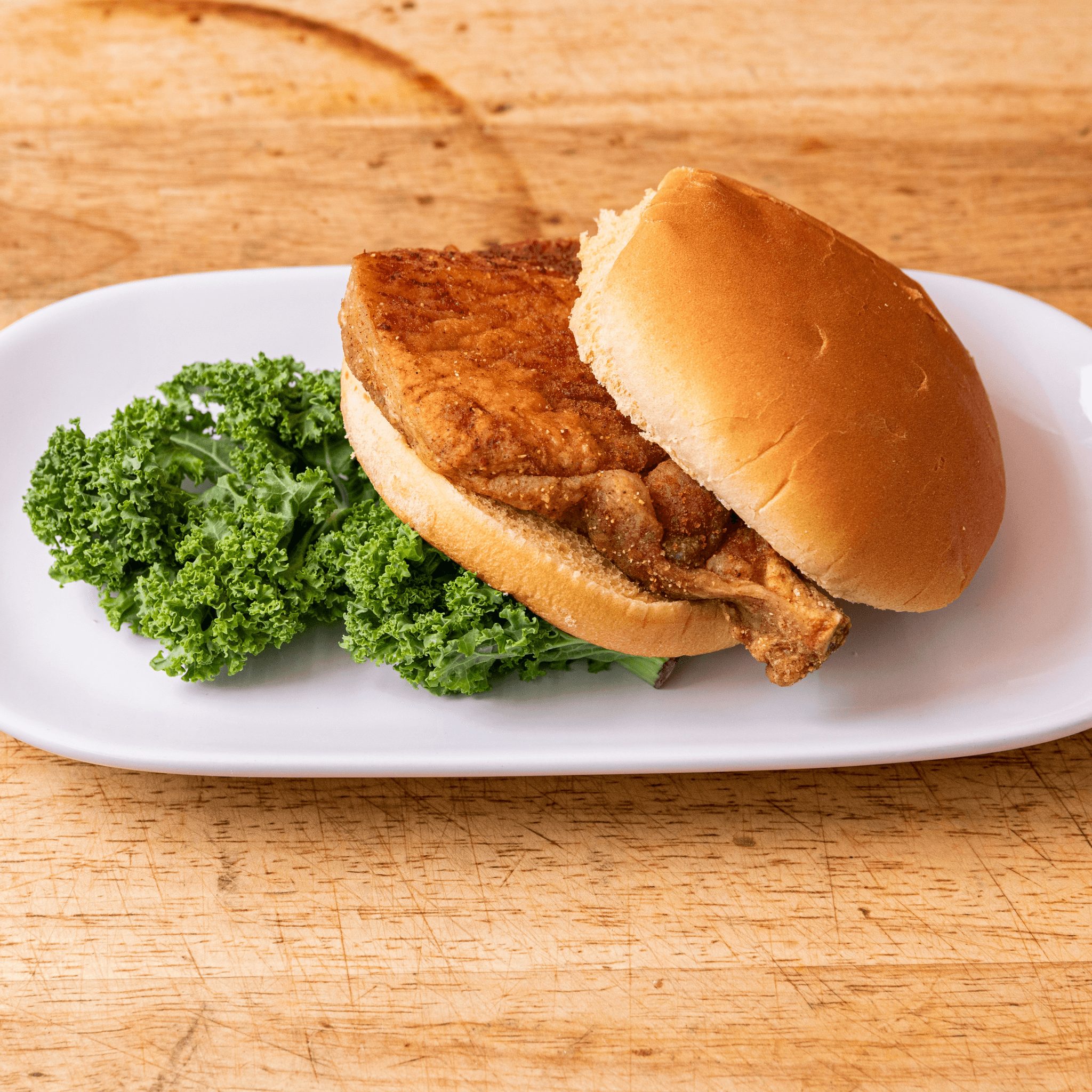 Bone-In Broasted Center Cut Pork Chop Sandwich.